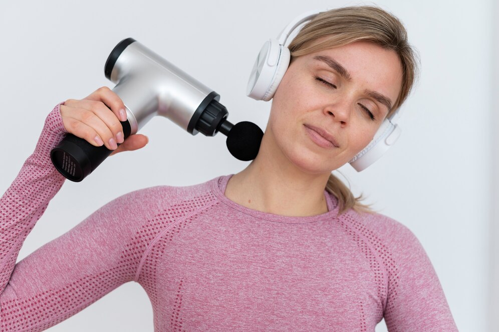 person using massage gun 23 2149398547